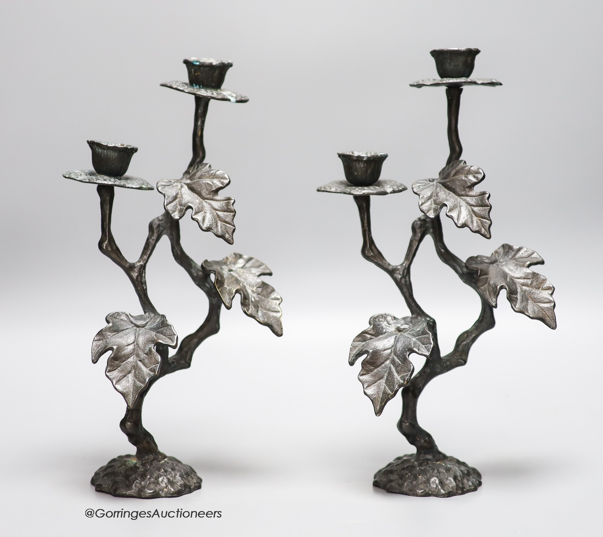 A pair of painted brass two branch candelabra, height 30cm